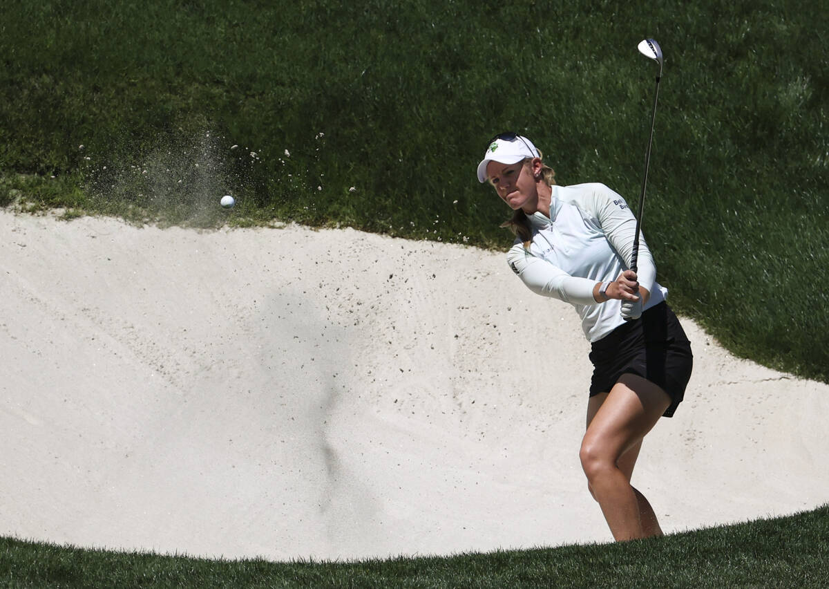 Amy Olson hits out from the bunker at the ninth hole during the second day of round-robin in th ...