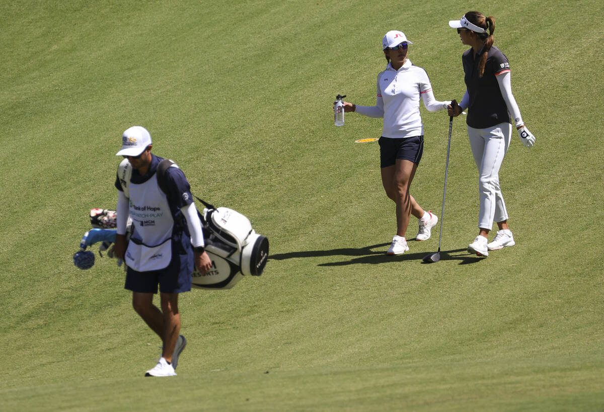 Tiffany Chan, second from left, and Alison Lee talk while walking the fairway at the ninth hole ...