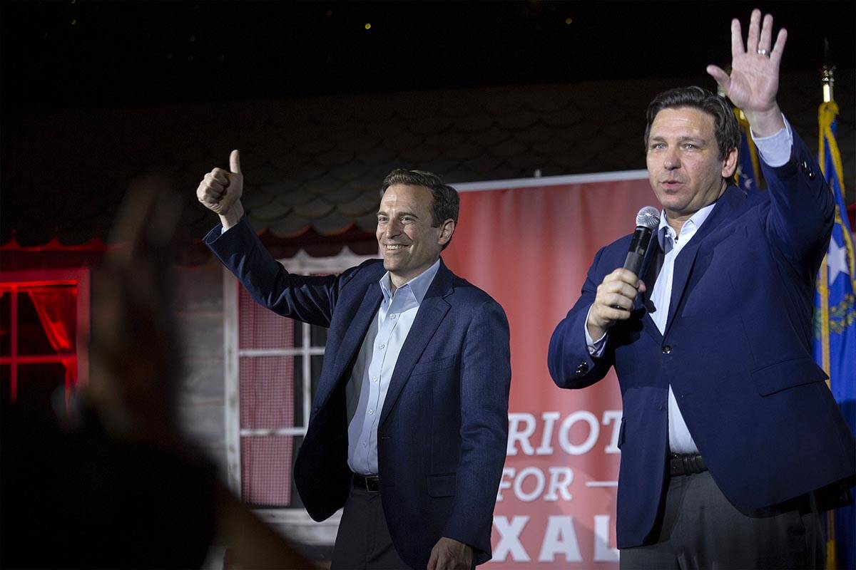 Nevada Republican U.S. Senate candidate Adam Laxalt, left, and Florida Gov. Ron DeSantis wave g ...