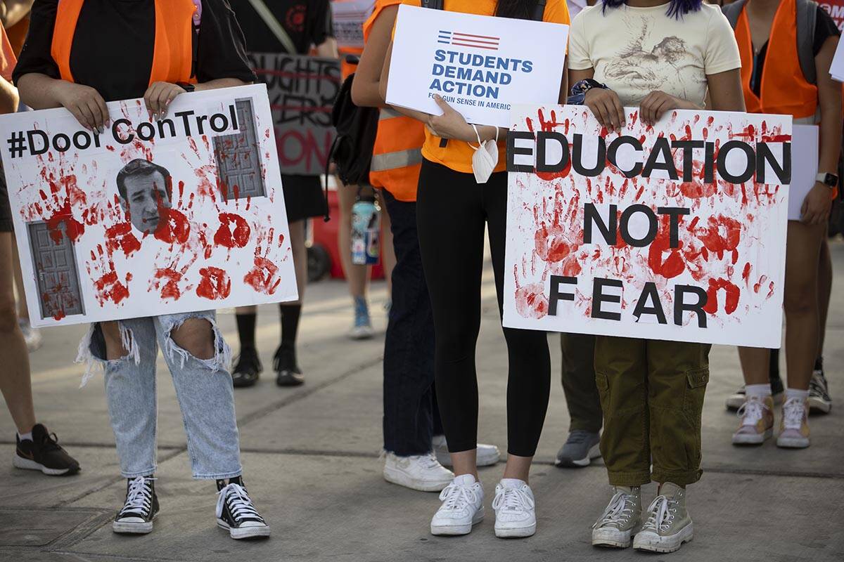 People participate during a rally and march by Moms Demand Action and Clark County School Distr ...