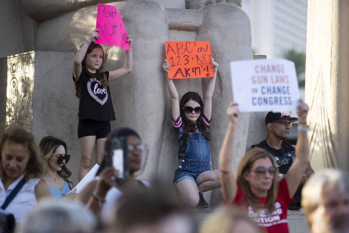 Amelia Likes, 6 left, and her sister Delilah, 8, of Las Vegas participate during a rally and ma ...