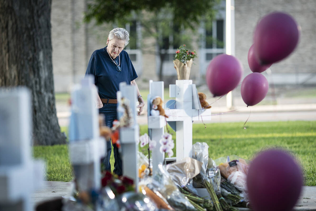 Eloise Castro, 75 a resident of Uvalde visits a memorial site to lay flowers and a candle in th ...