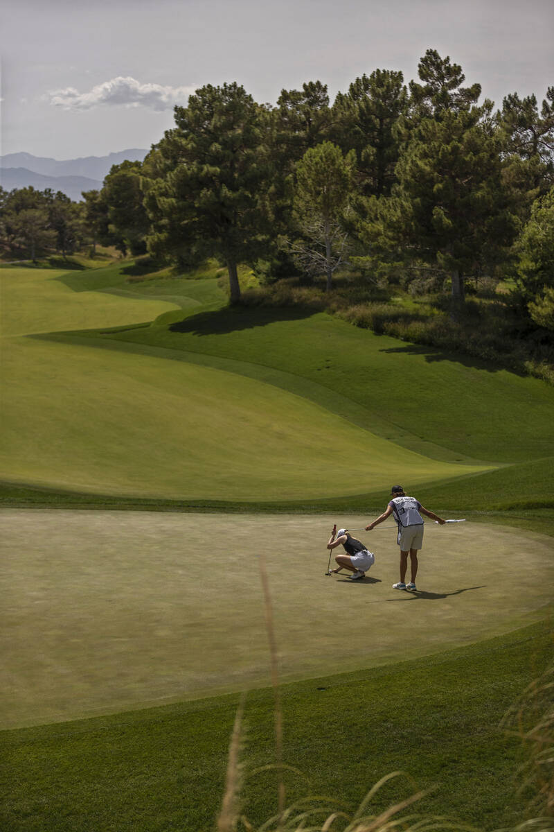 Jodi Ewart Shadoff, left, and her caddy read the green on the 5th hole during the fourth day of ...