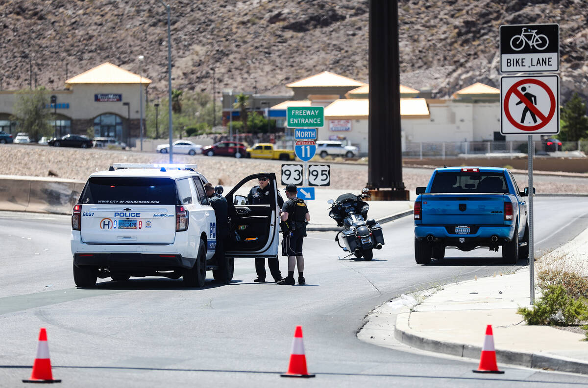 Police at the entrance to US 95 on Horizon Drive where at least one person was shot on the high ...