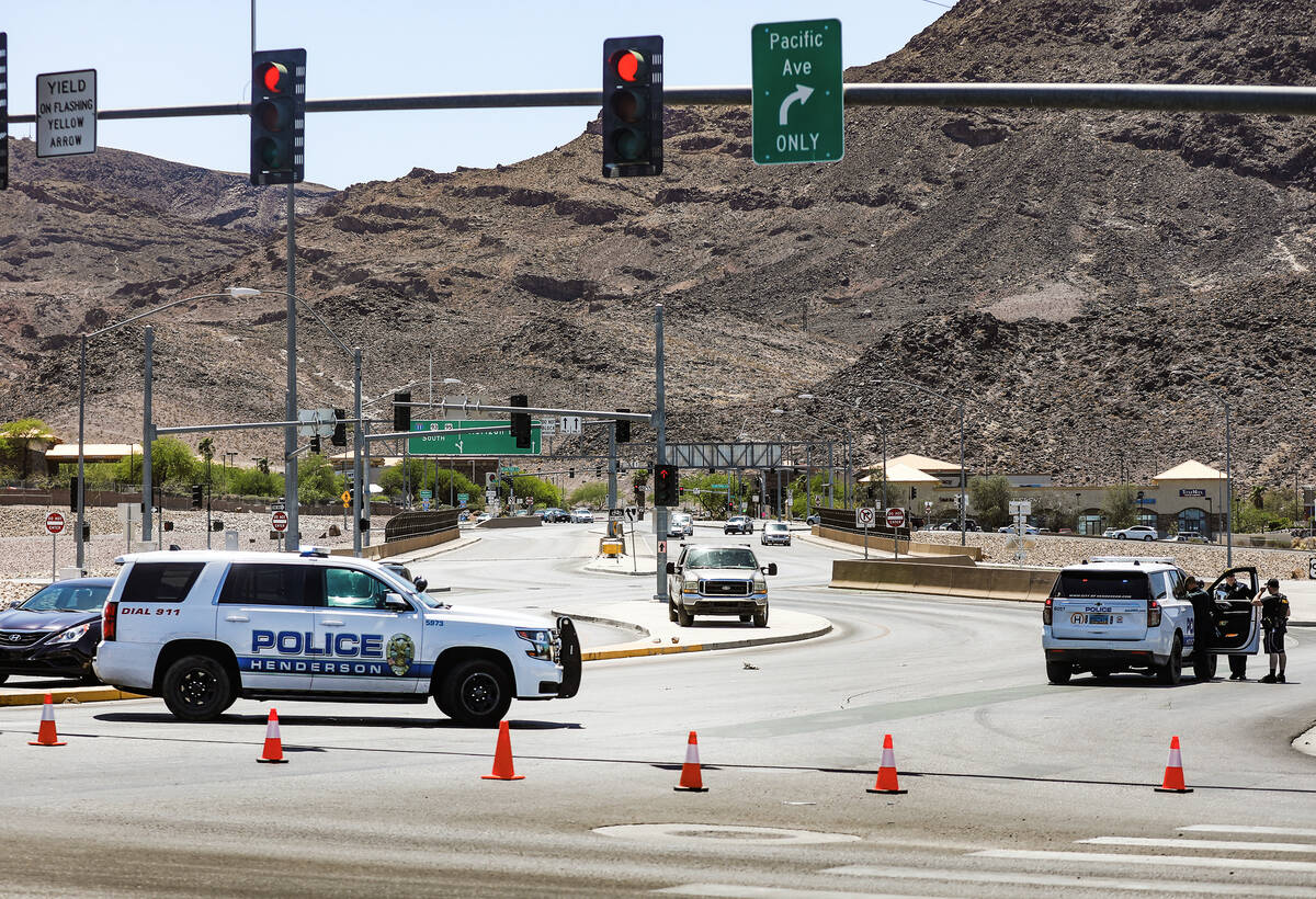 Police at the entrance to US 95 on Horizon Drive where at least one person was shot on the high ...