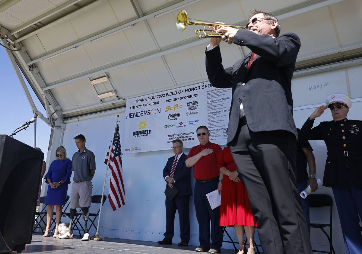 Lance Phelps plays Taps, Monday, May 30, 2022, at Cornerstone Park in Henderson, during the 202 ...