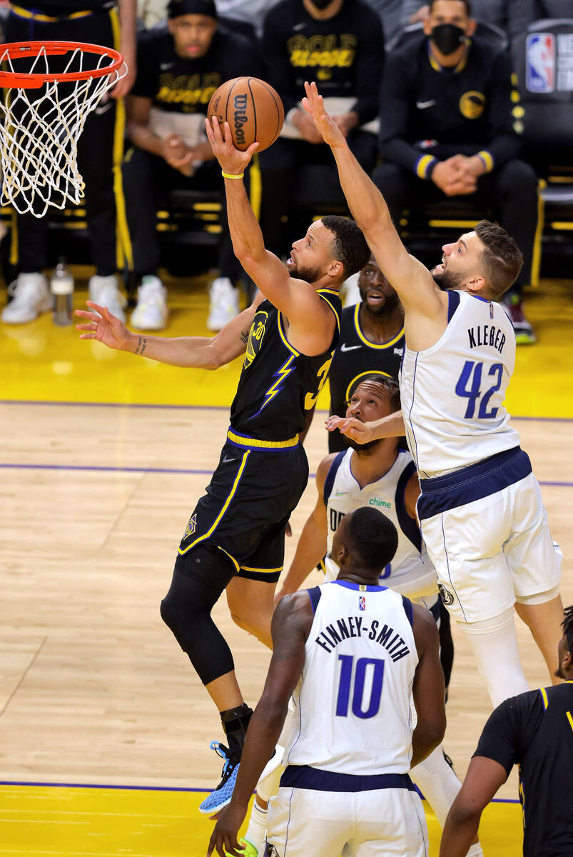 Golden State Warriors' Stephen Curry (30) next to Dallas Mavericks' Maxi Kleber in Game 5 of th ...