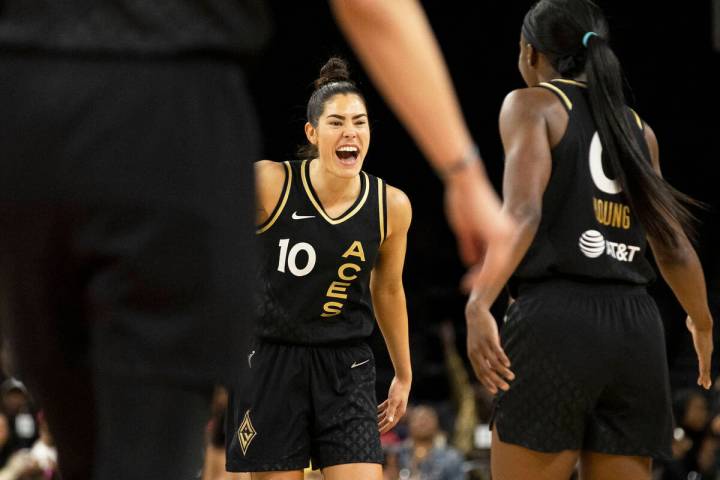 Aces guard Kelsey Plum (10) celebrates a big offensive play with teammate Jackie Young (0) in t ...