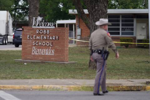 An officer walks outside of Robb Elementary School in Uvalde, Texas, on Tuesday, May 24, 2022. ...