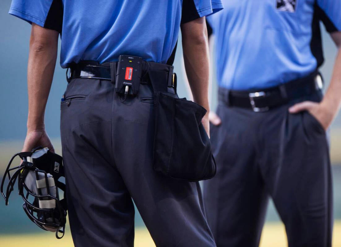 Home plate umpire Takahito Matsuda, left, using the Automated Ball-Strike system during a minor ...