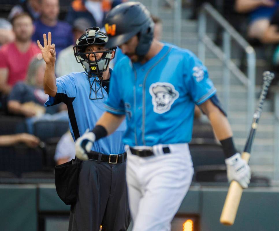 Home plate umpire Takahito Matsuda, top/left, confirms the strike out of Aviators Drew Jackson ...