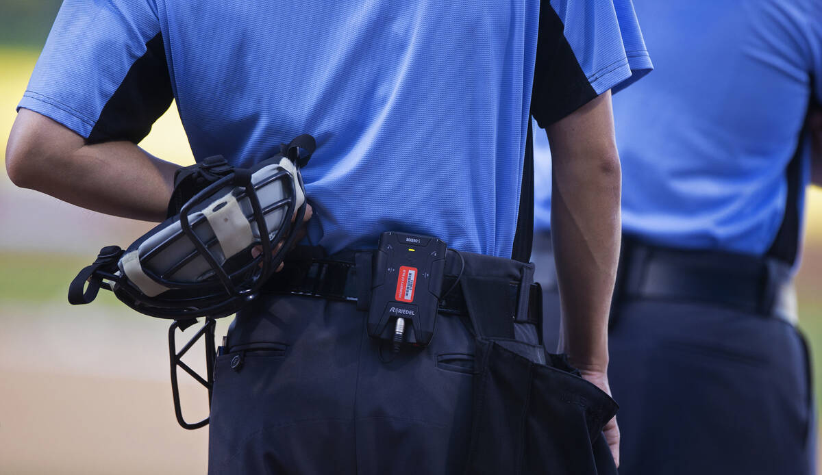 Home plate umpire Takahito Matsuda, left, using the Automated Ball-Strike system during a minor ...