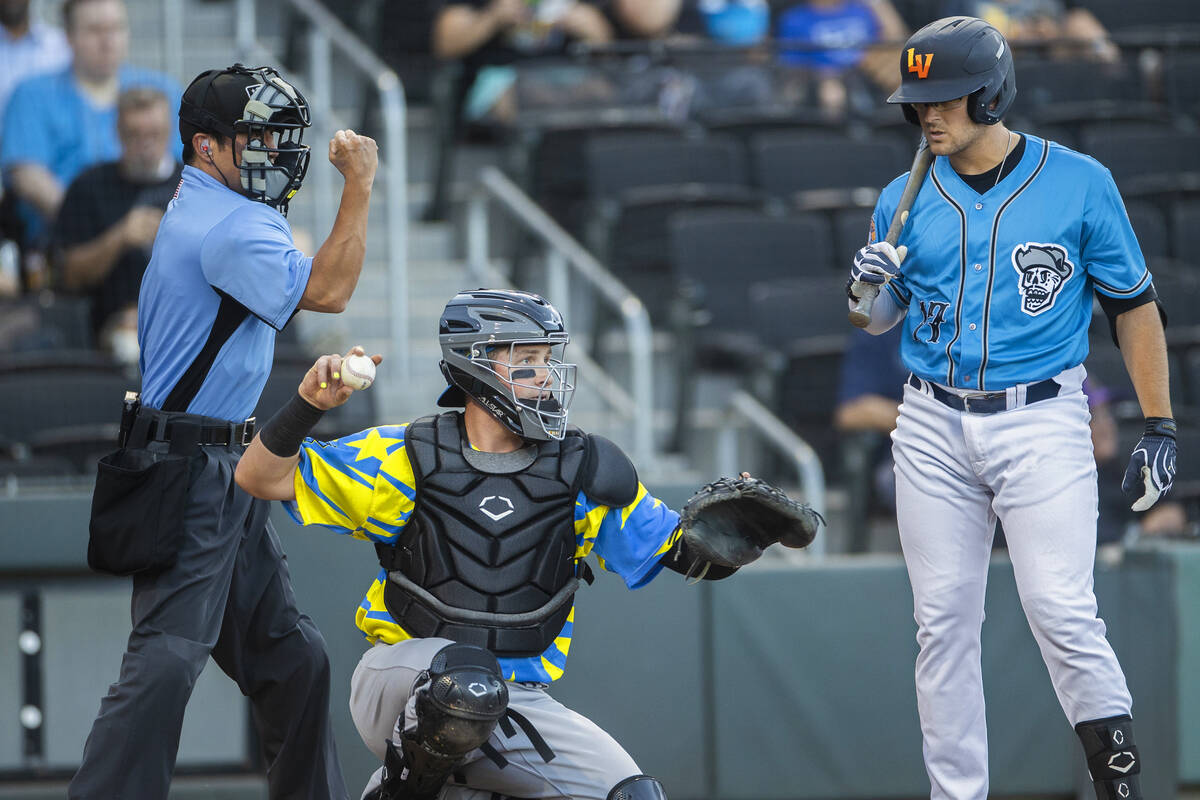 Home plate umpire Takahito Matsuda, left, confirms a strike against the Aviators Jonah Bride (1 ...