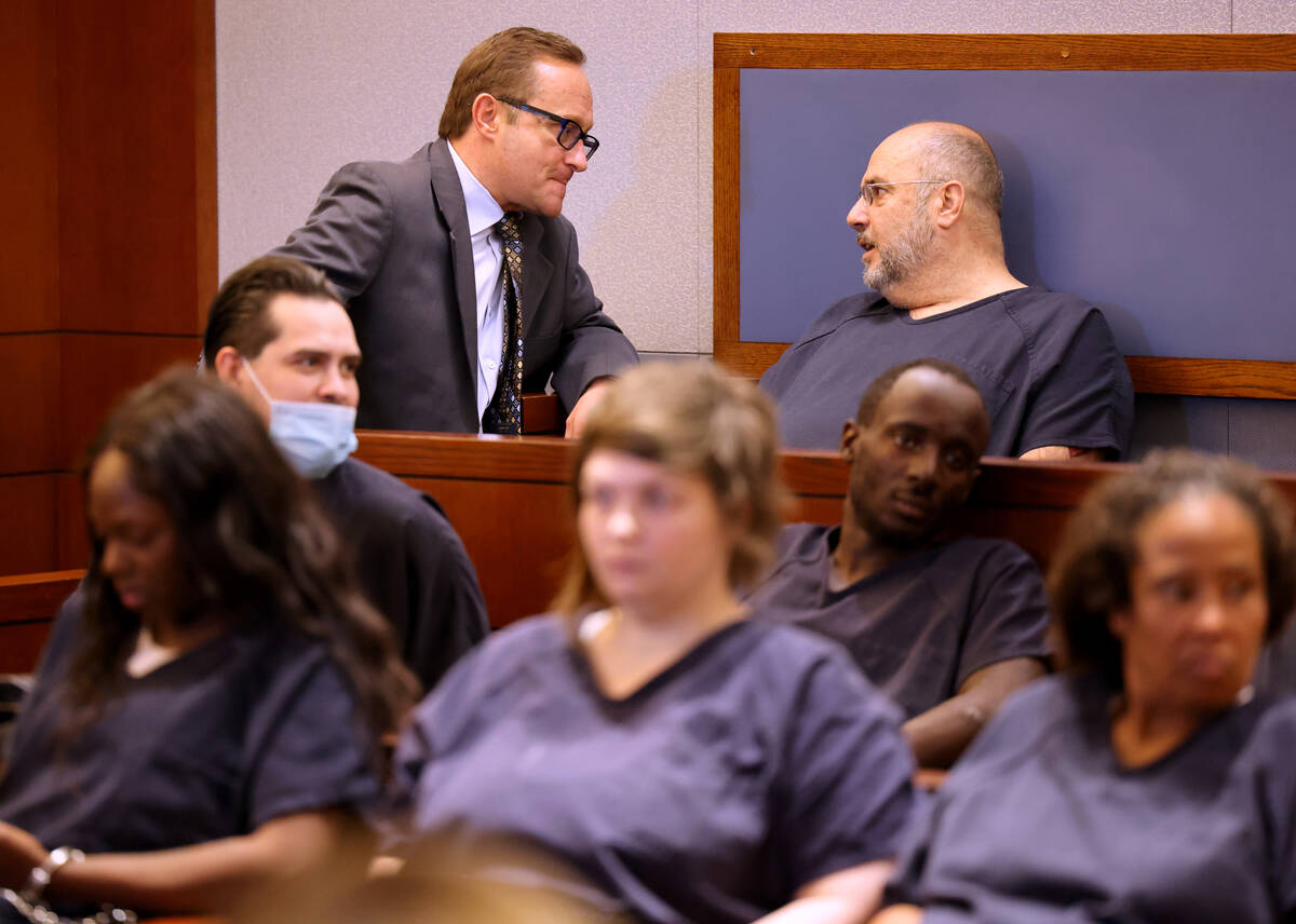 Attorney Douglas Crawford, 67, talks to his attorney, Tony Abbatangelo, while waiting to make h ...