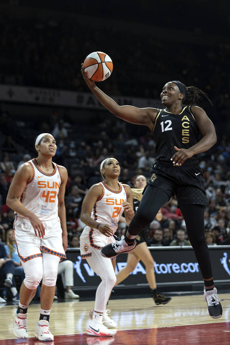 Las Vegas Aces guard Chelsea Gray (12) shoots a layup while Connecticut Sun center Brionna Jone ...