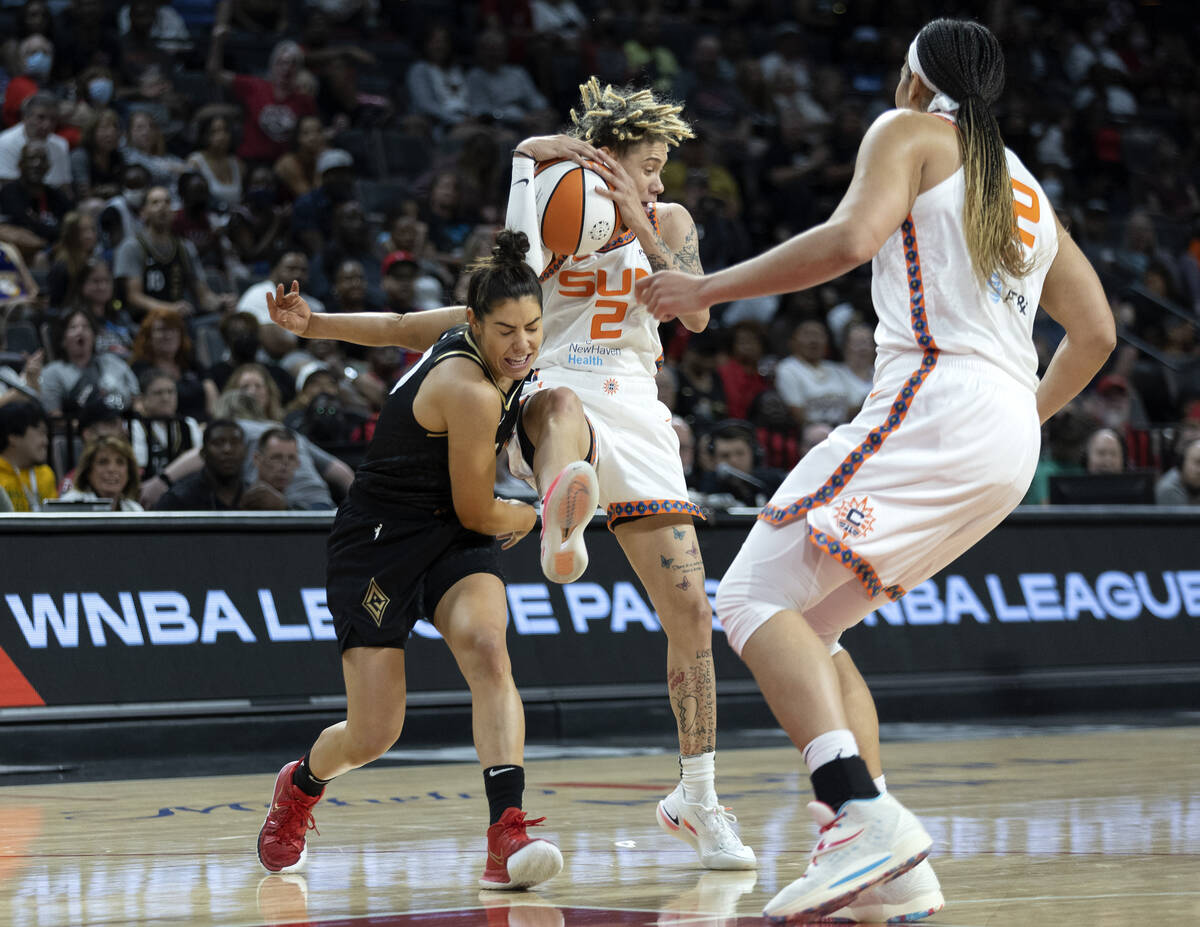 Las Vegas Aces guard Kelsey Plum (10) collides with Connecticut Sun guard Natisha Hiedeman (2) ...