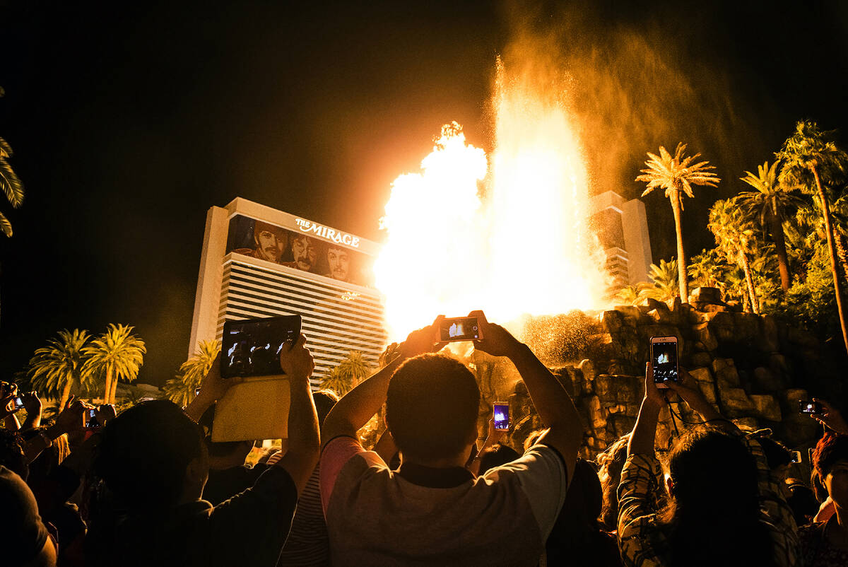 A large crowd gathers to watch the volcano erupt at The Mirage on the Strip in Las Vegas. (Benj ...