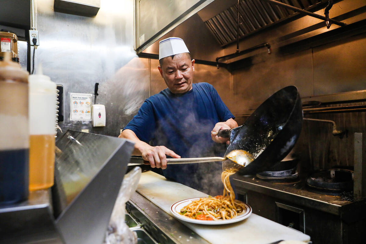 Chef Peter Xing plates a dish during lunch hour at his restaurant Big Dan Shanxi Taste inside ...