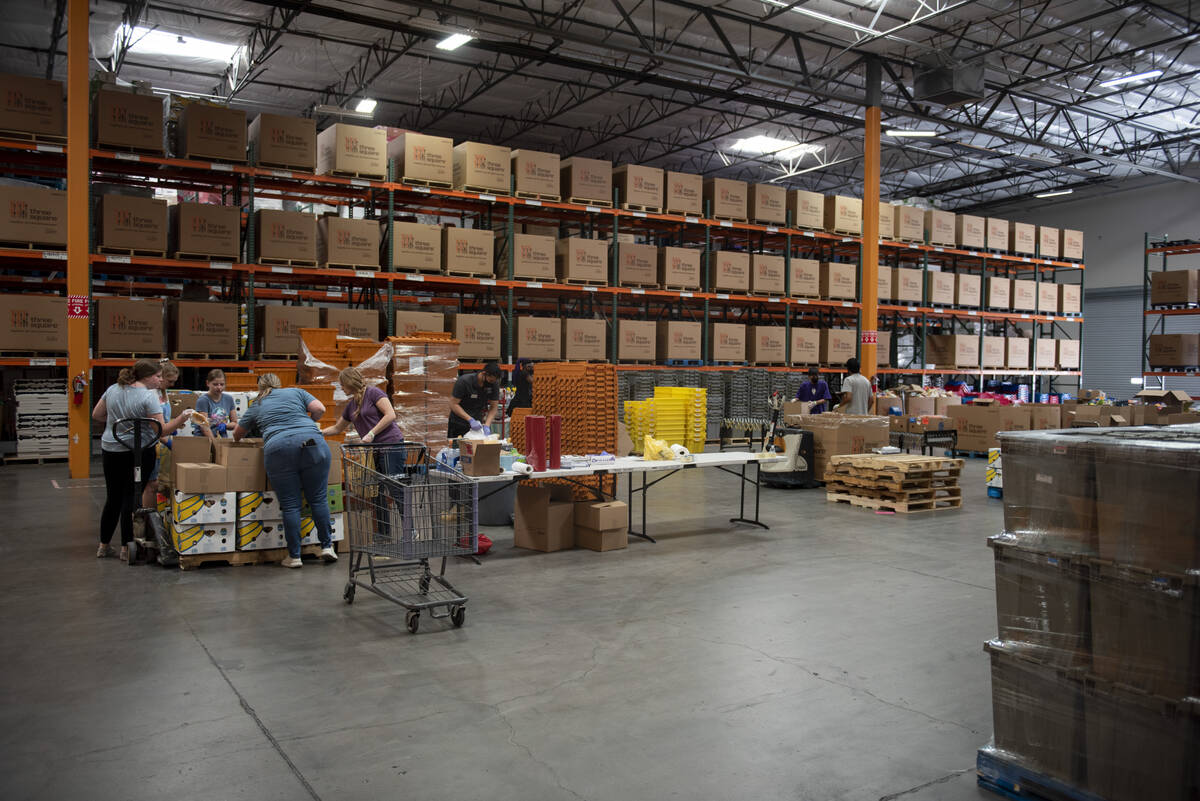 Volunteers help sort food in the warehouse at Three Square, the food bank serving Southern Neva ...