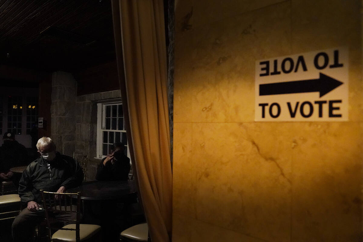 FILE - In this Jan. 5, 2021, file photo, voters wait in line to cast their ballots in Georgia's ...