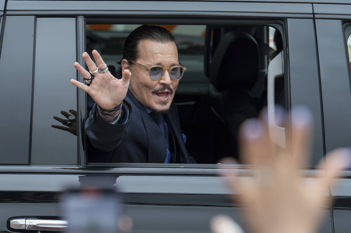 Actor Johnny Depp waves to supporters as he departs the Fairfax County Courthouse Friday, May 2 ...