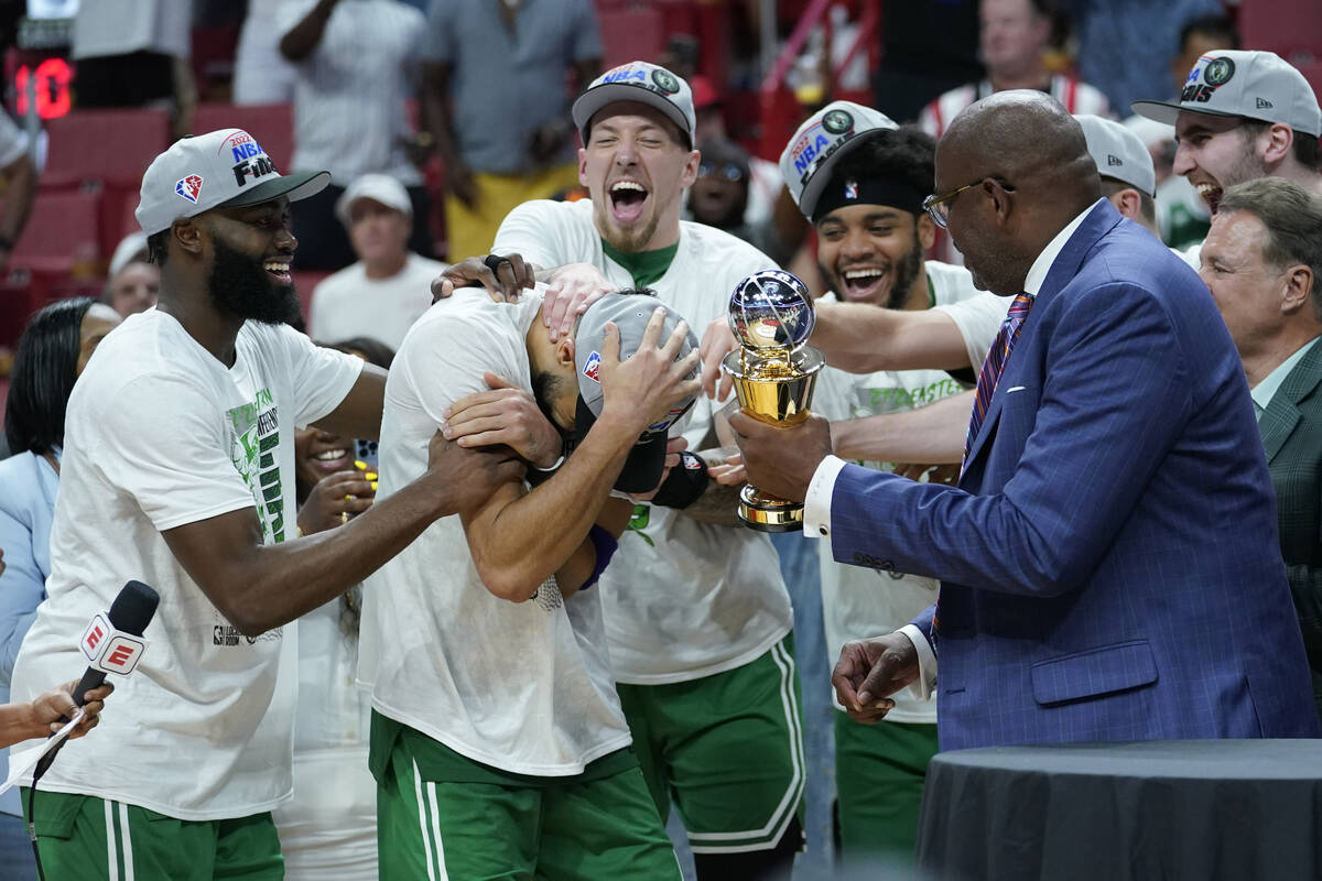 Boston Celtics forward Jayson Tatum (0) receives the NBA Eastern Conference MVP trophy after de ...