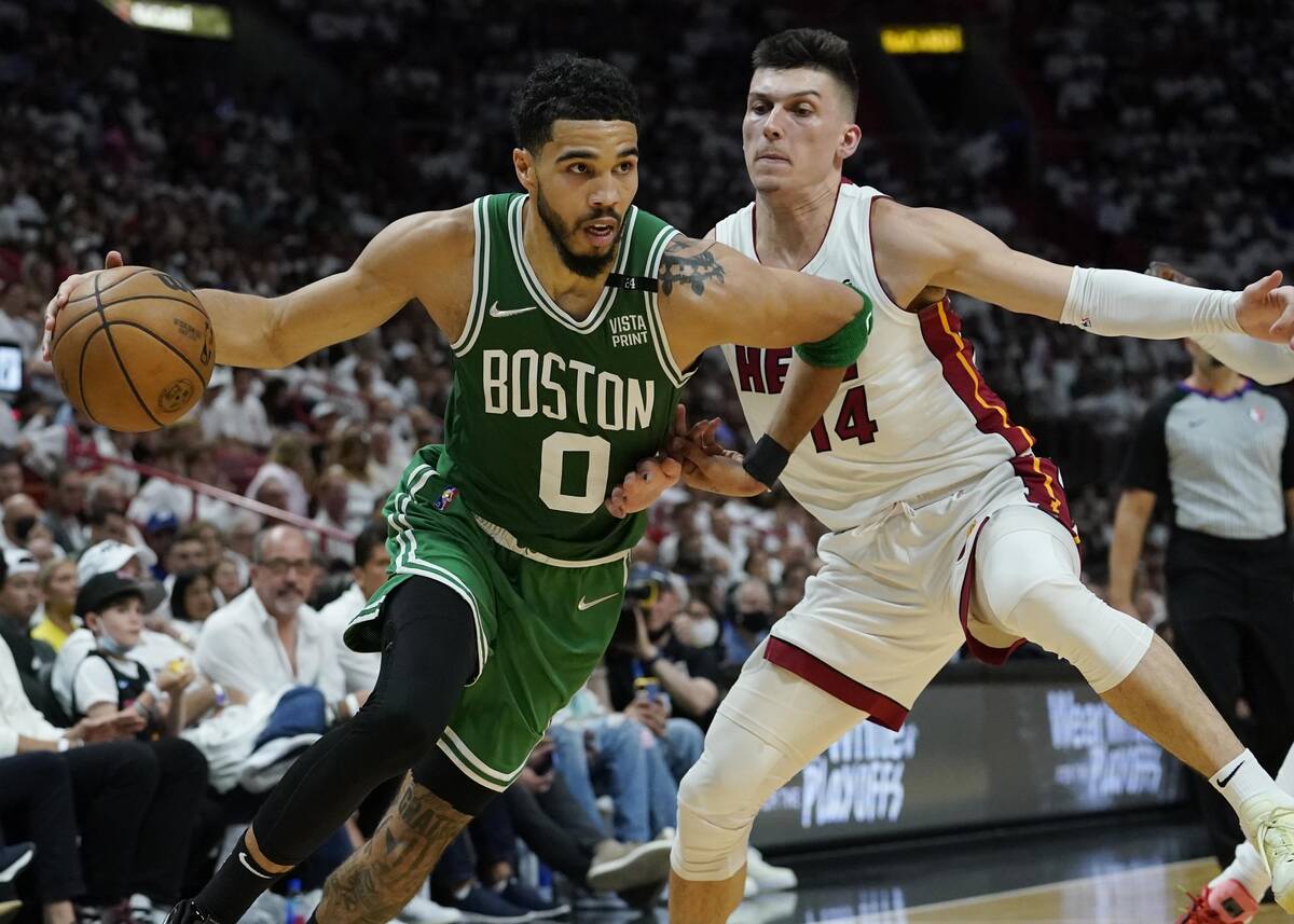 Boston Celtics forward Jayson Tatum (0) dribbles the ball as Miami Heat guard Tyler Herro (14) ...