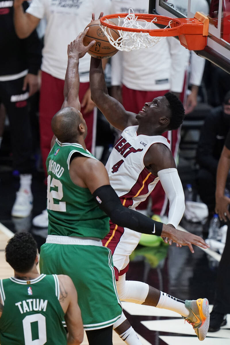 Boston Celtics center Al Horford (42) blocks a shot to the basket by Miami Heat guard Victor Ol ...
