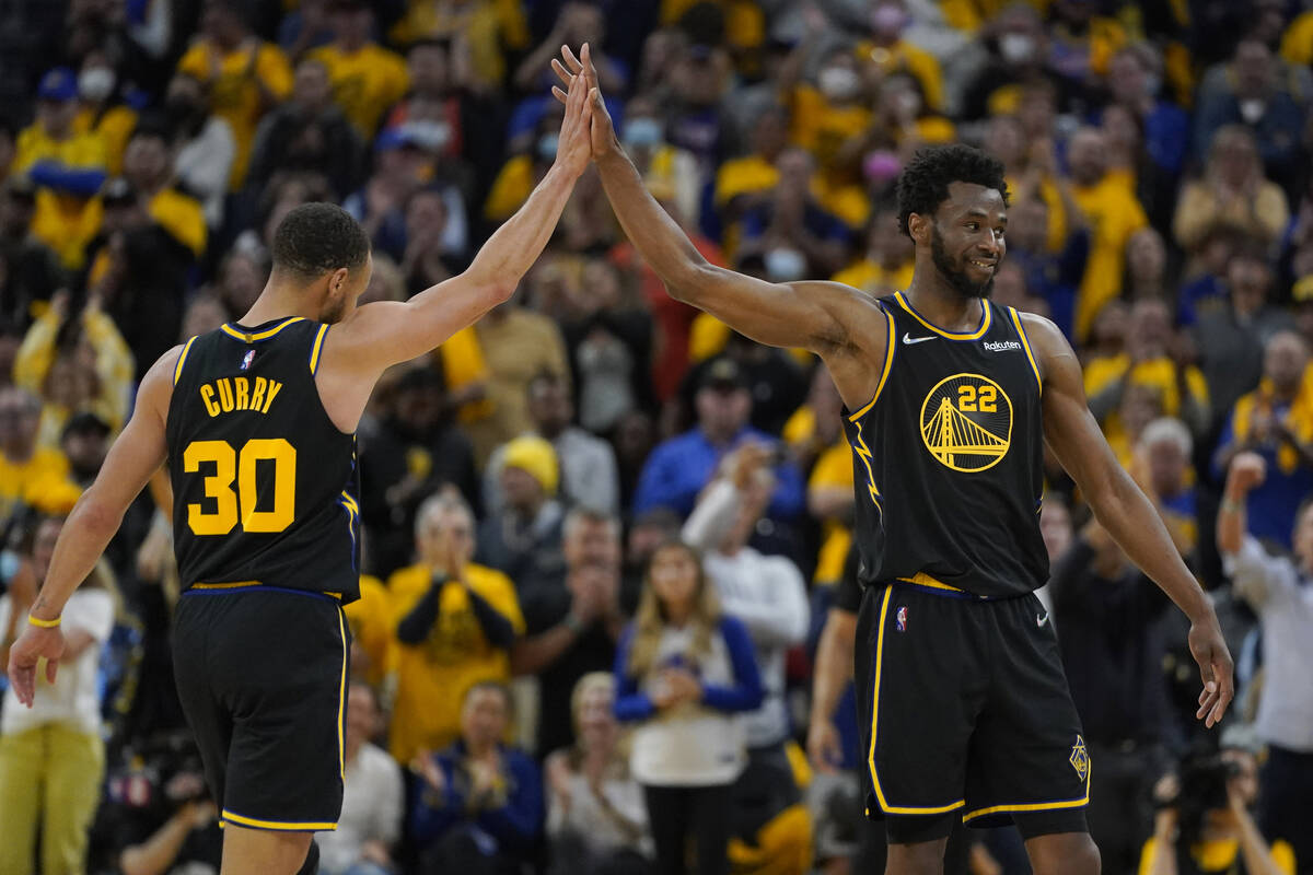 Golden State Warriors guard Stephen Curry (30) celebrates with forward Andrew Wiggins (22) duri ...