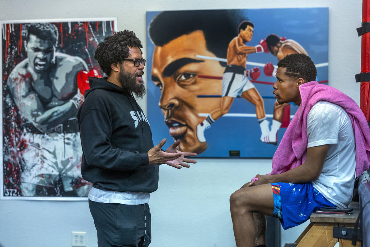 Trainer and father Bill Haney, left, talks with WBC lightweight boxer Devin Haney during a work ...