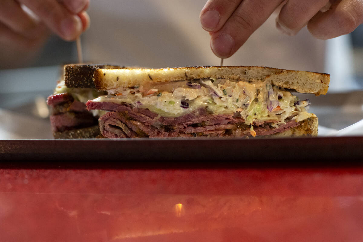 A chef prepares the pastrami reuben during restaurant concept Dinette’s judging event in ...