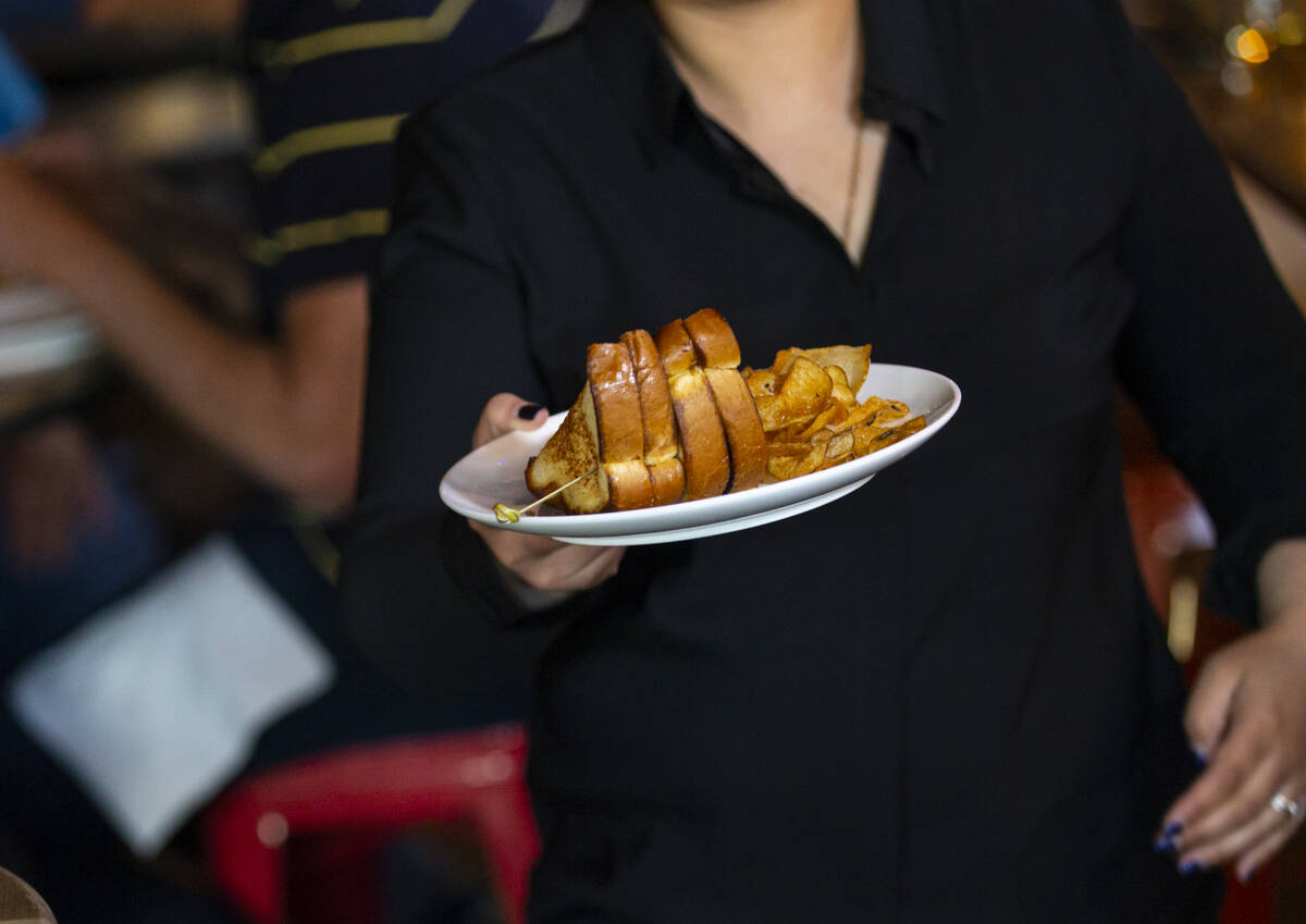 Waitress Blanca Prado carries Jersey Boys PBJ&B sandwiches during a presentation by Random ...