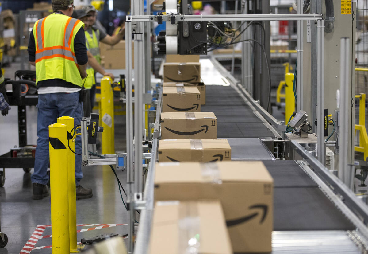 Boxes move down a conveyor belt during a tour of Amazon's North Las Vegas fulfillment center in ...