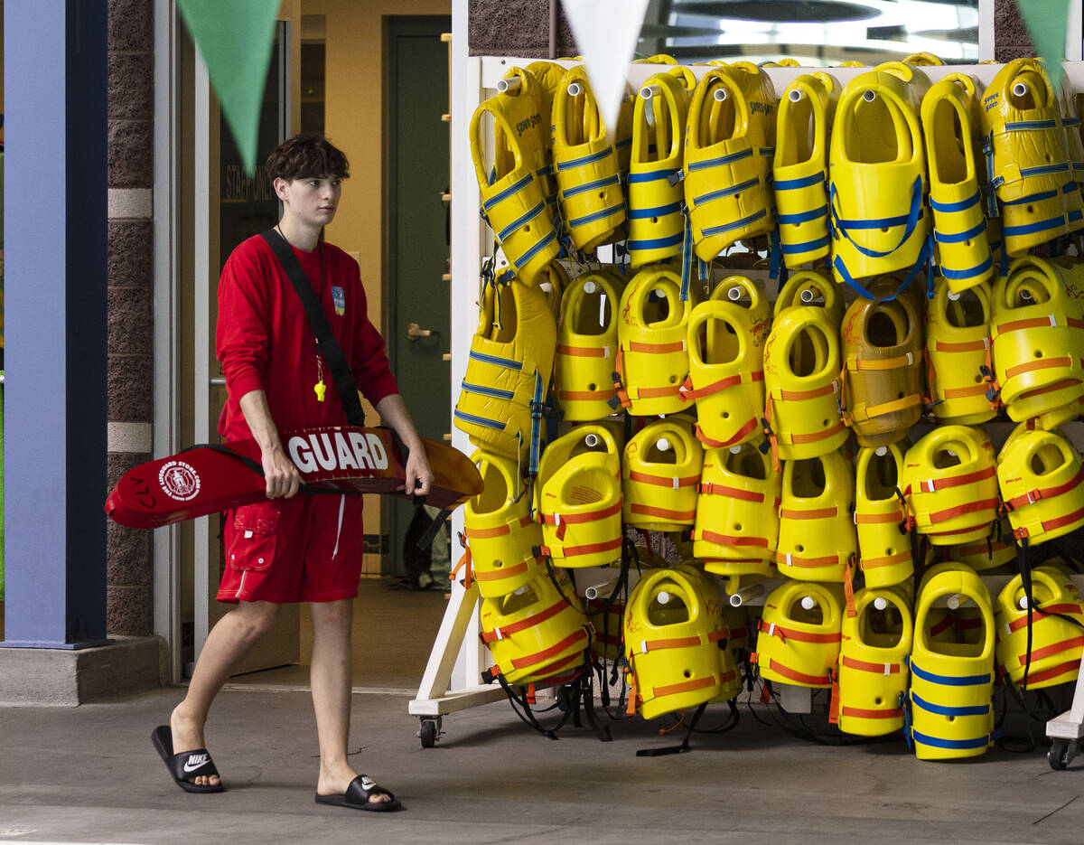 Aiden Ruggiutz, 18, a lifeguard, walks to his position as he starts his shift at Pavilion Cente ...