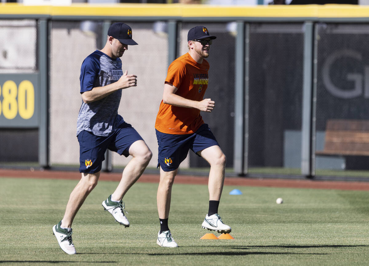 Aviator's pitchers Adam Kolarek, left, and Jared Koenig, warm up during team's practice at Las ...