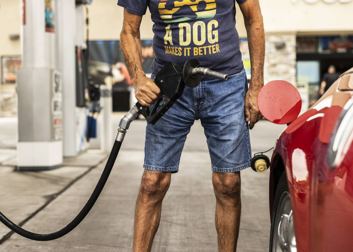 John Lasco pumps gas at Lucky Spot Chevron on Saturday, June 4, 2022, in Las Vegas. (Benjamin H ...