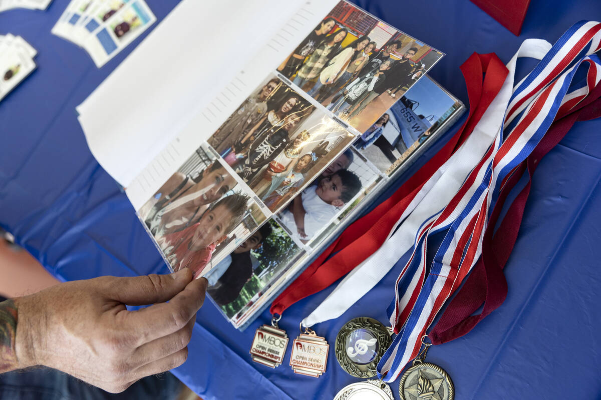 A blood donor flips through scrapbooks during a blood drive inspired by Joseph Landolfi, who di ...