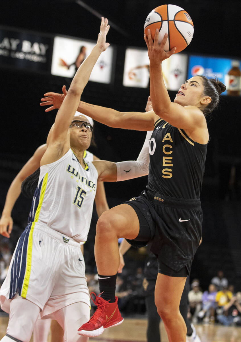 Aces guard Kelsey Plum (10) drives past Dallas Wings guard Allisha Gray (15) in the second half ...