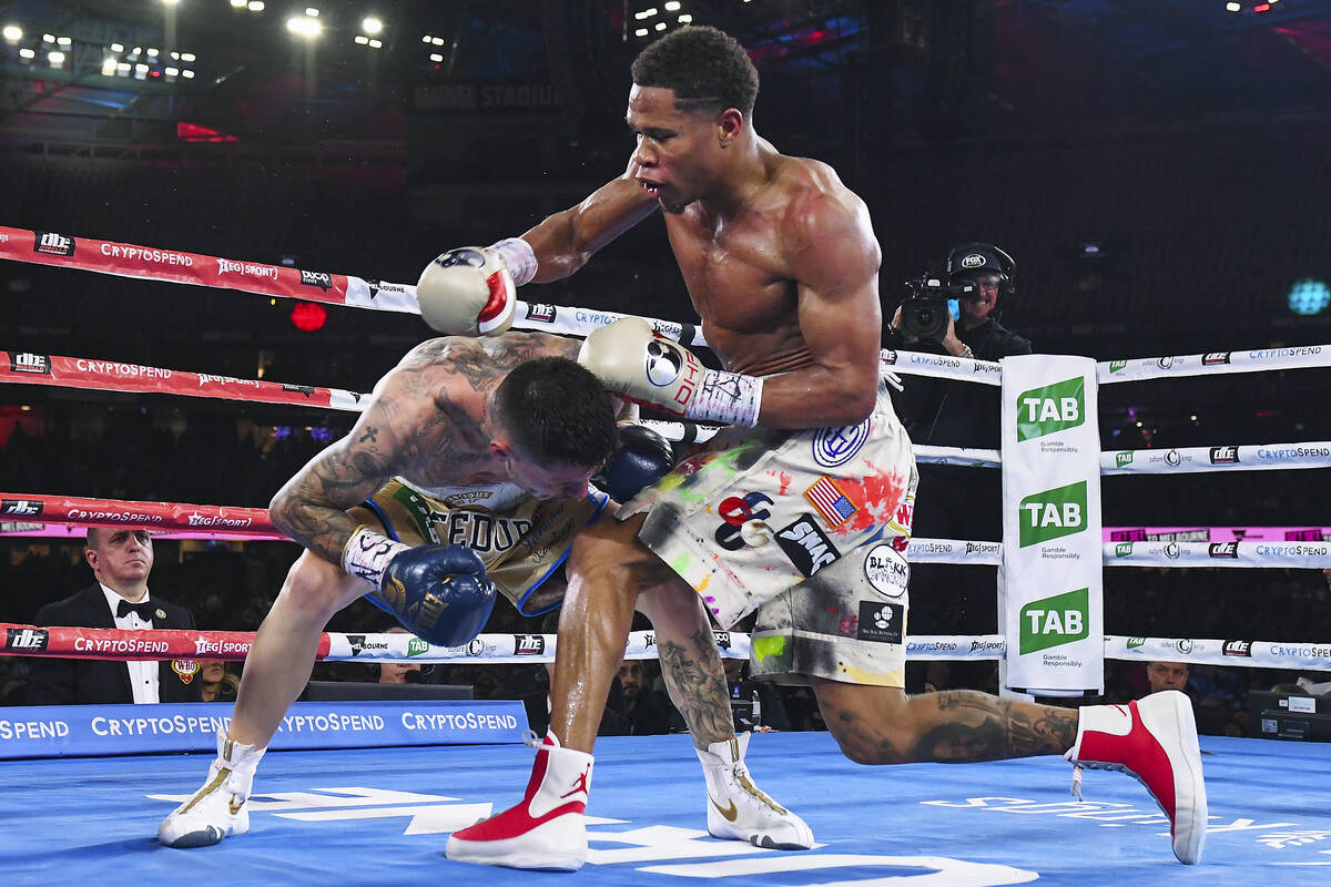Devin Haney, right, of the United States, fights during his bout against Australia's George Kam ...