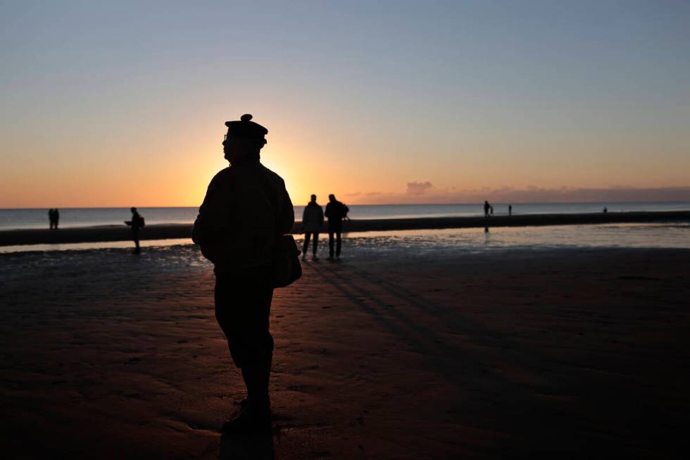 A World War II reenactor pays tribute to soldiers during a D-Day commemoration ceremony of the ...