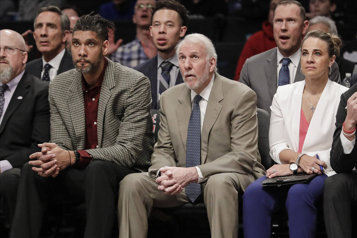 San Antonio Spurs head coach Gregg Popovich, center, watches his players with assistant coaches ...