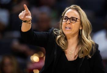 Aces head coach Becky Hammon directs her team in the second half during a WNBA basketball game ...