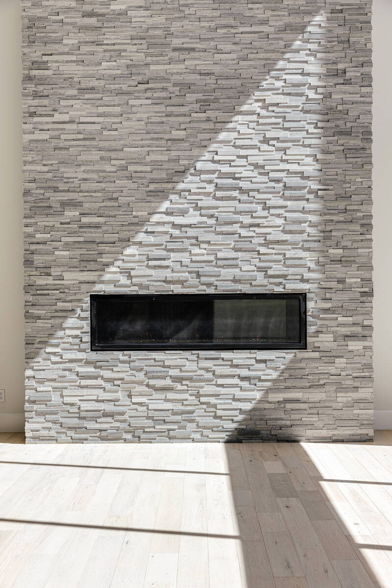 Ivan Sher Group The main living room showcases a floor-to-ceiling blue-honed marble fireplace.