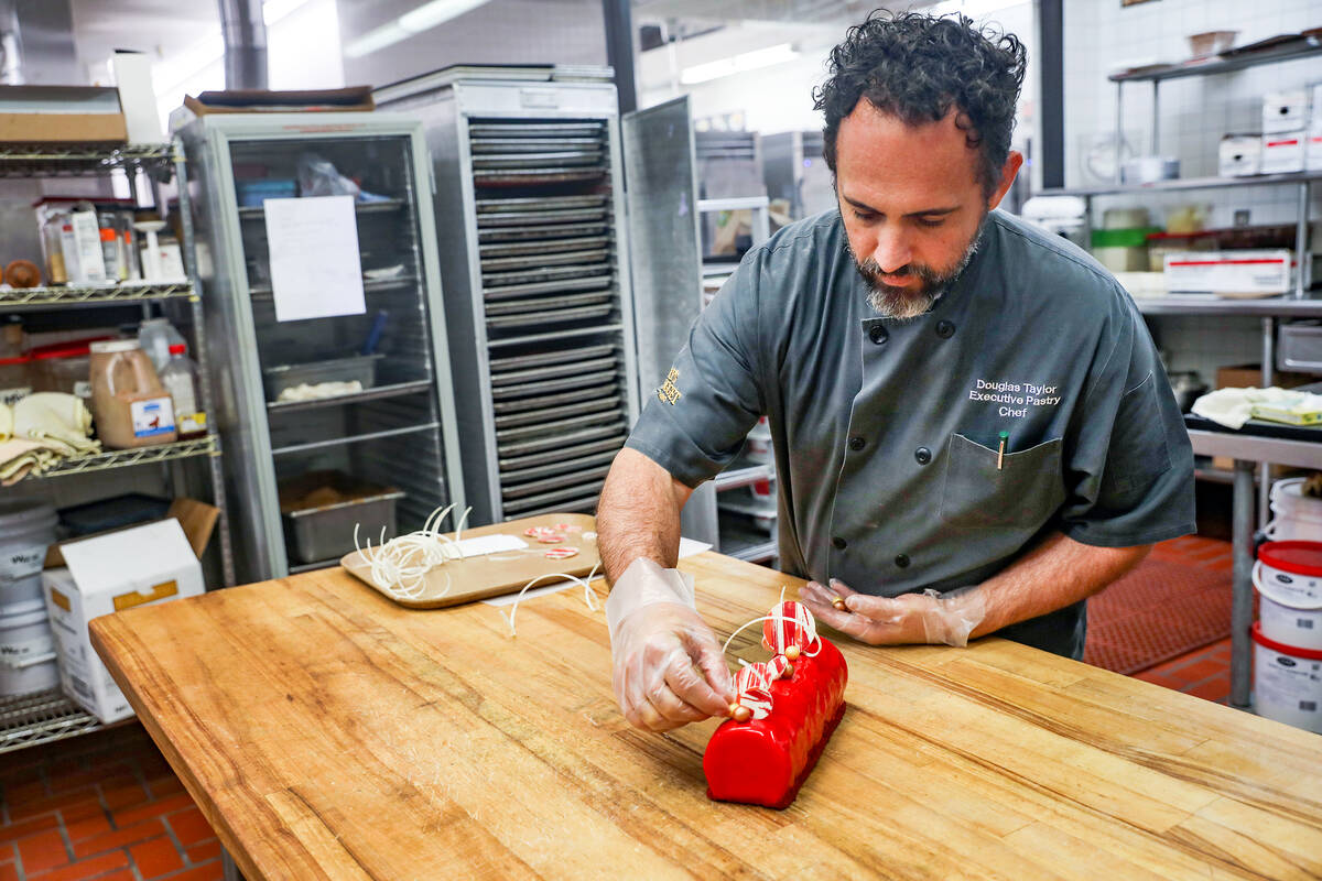 Executive Pastry Chef Doug Taylor adds finishing touches to a Father’s Day special panna cott ...