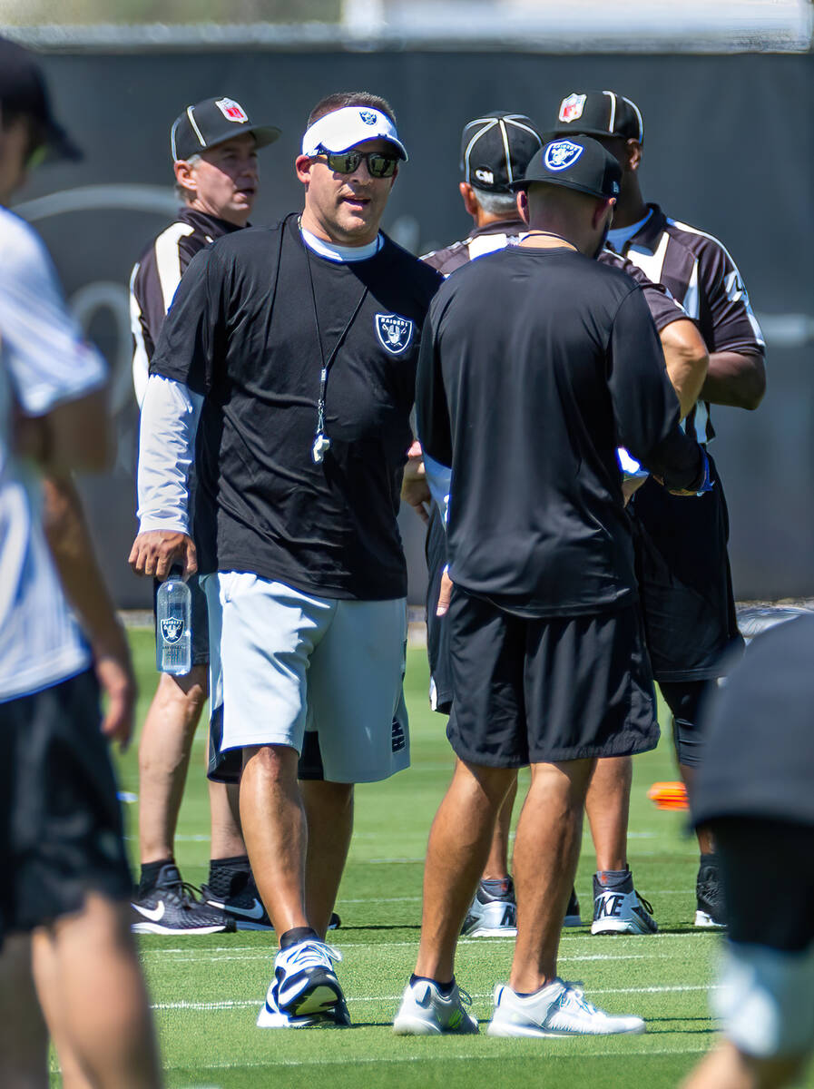 Raiders Josh McDaniels, center, talks on the field during minicamp practice at the Raiders head ...