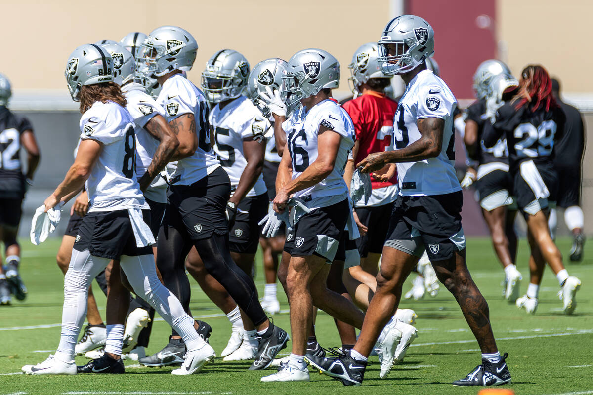 Raiders tight end Darren Waller (83, right) walks with teammates during minicamp practice at th ...