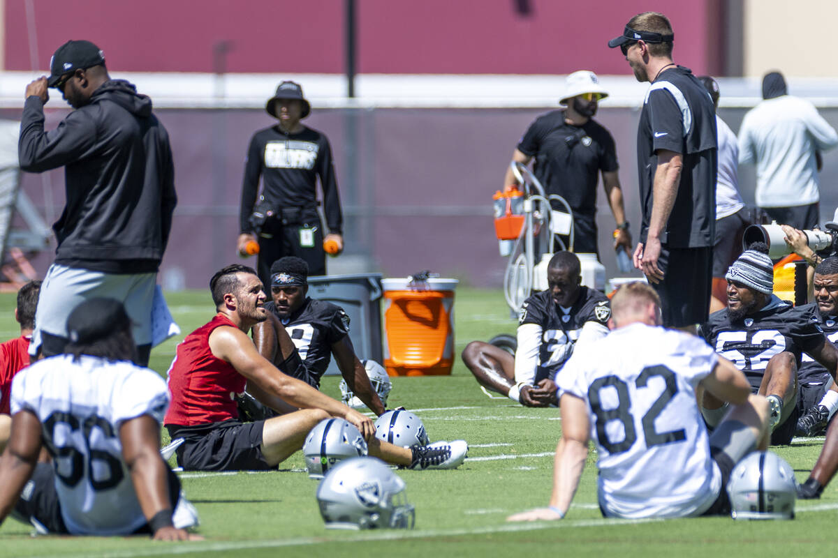 Raiders quarterback Derek Carr (4, left) talks with teammates as they stretch during minicamp p ...