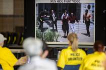 Attendees watch a video addressing active shooter tactics at Spring Valley High School on Tues ...