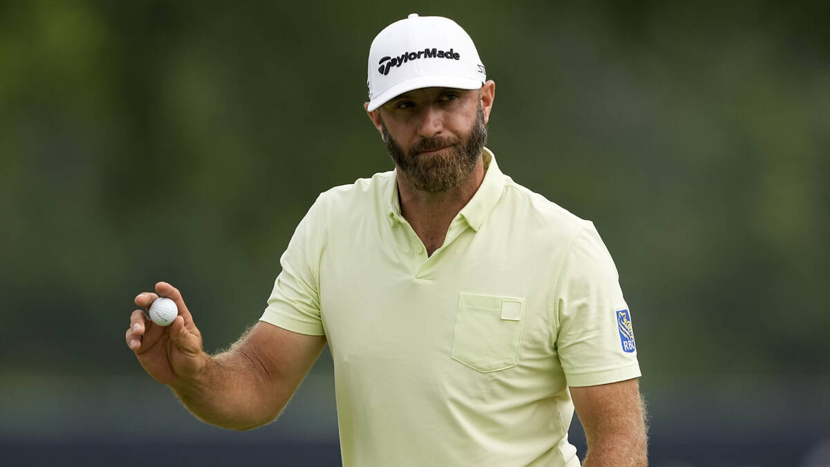 Dustin Johnson waves after making a putt on the 17th hole during the second round of the PGA Ch ...