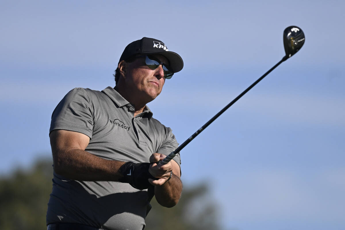 FILE - Phil Mickelson hits his tee shot on the fifth hole of the South Course at Torrey Pines d ...